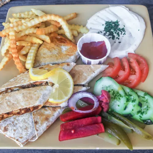Arabic Shawarma Plate - Beef or chicken slices with fries, pickles, and garlic sauce.