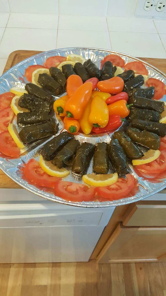 Dolmas - 6 grape leaves stuffed with rice, lemon, onion and herbs.