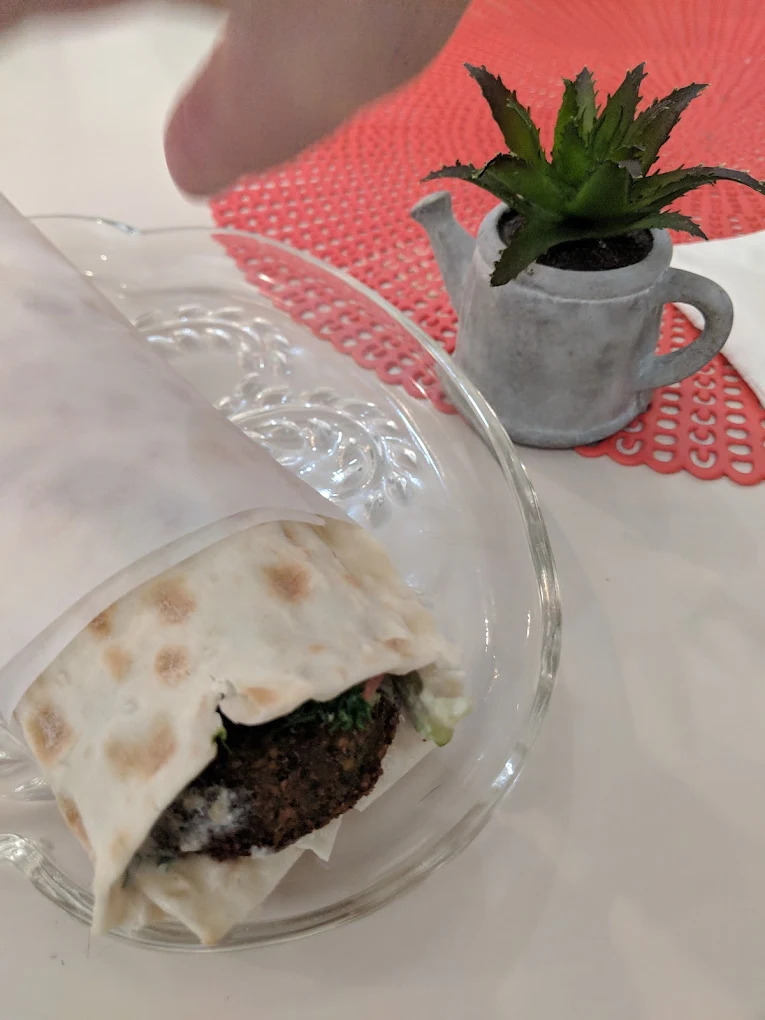 Green Falafel Sandwich - Falafel with green lettuce, tabouli mix, hummus and tahini on lavash bread.