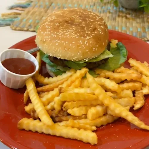 King Burger - Grilled ground beef with parsley, onions and spices, served with tomato, onion and fries.