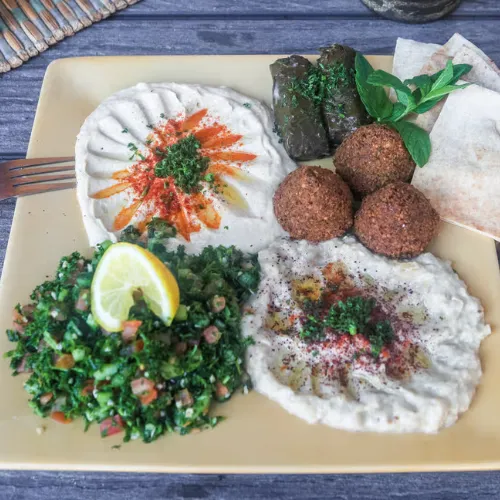 King Sampler Plate - Tabouli salad, hummus, baba ghanouj, dolma, 3 falafels and pita bread.